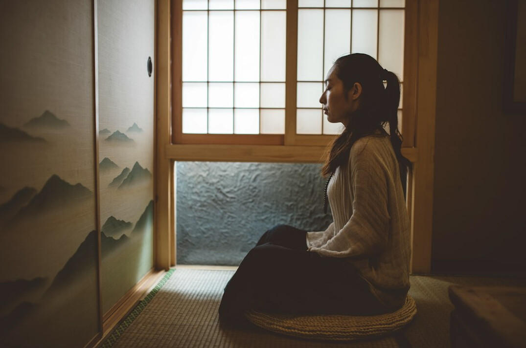 person meditating alone