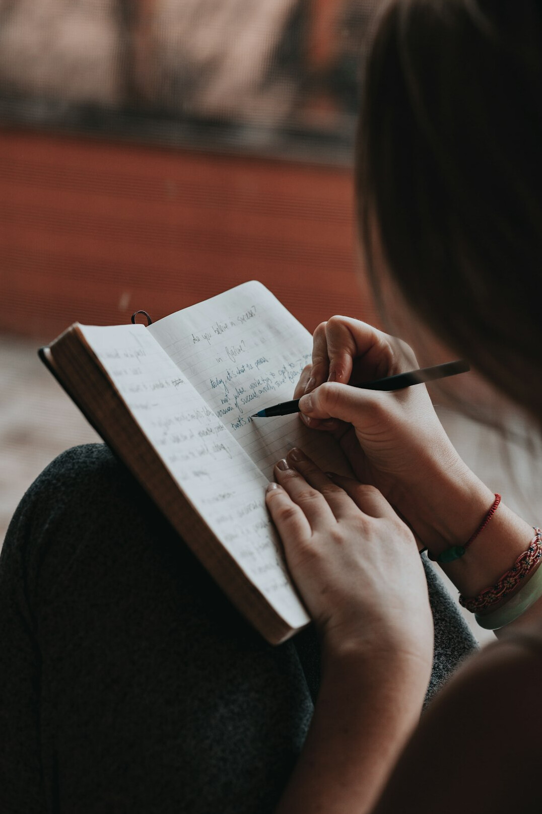 person setting goals on notebook